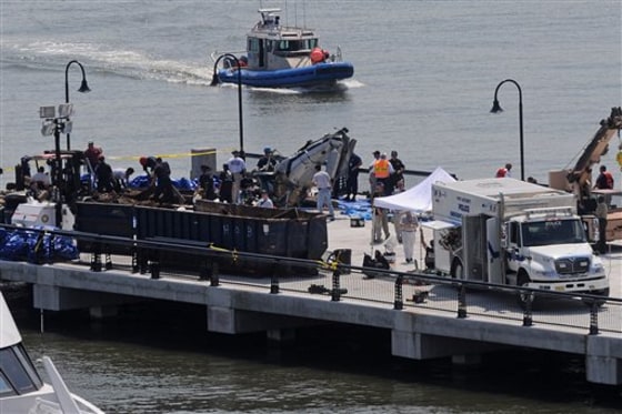 The wreckage of a helicopter that collided with a private plane is seen Aug. 10, 2009, on a Hoboken, N.J., pier.